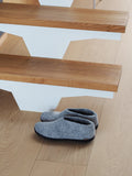 Gray slippers on a wooden staircase