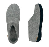 Grey slippers with a textured sole on a white background