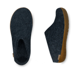 Pair of dark blue slippers with brown soles on a white background