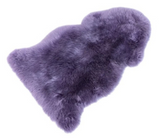 Purple sheepskin rug on a white background