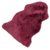 red sheepskin rug on a white background